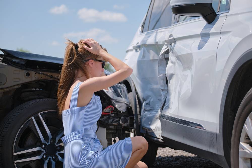 Woman Looking At A Bump On A Car