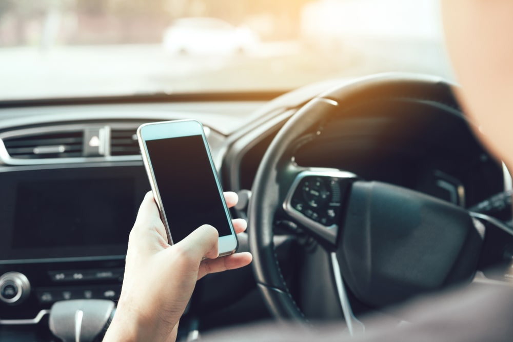 Person Holding A Phone While Driving