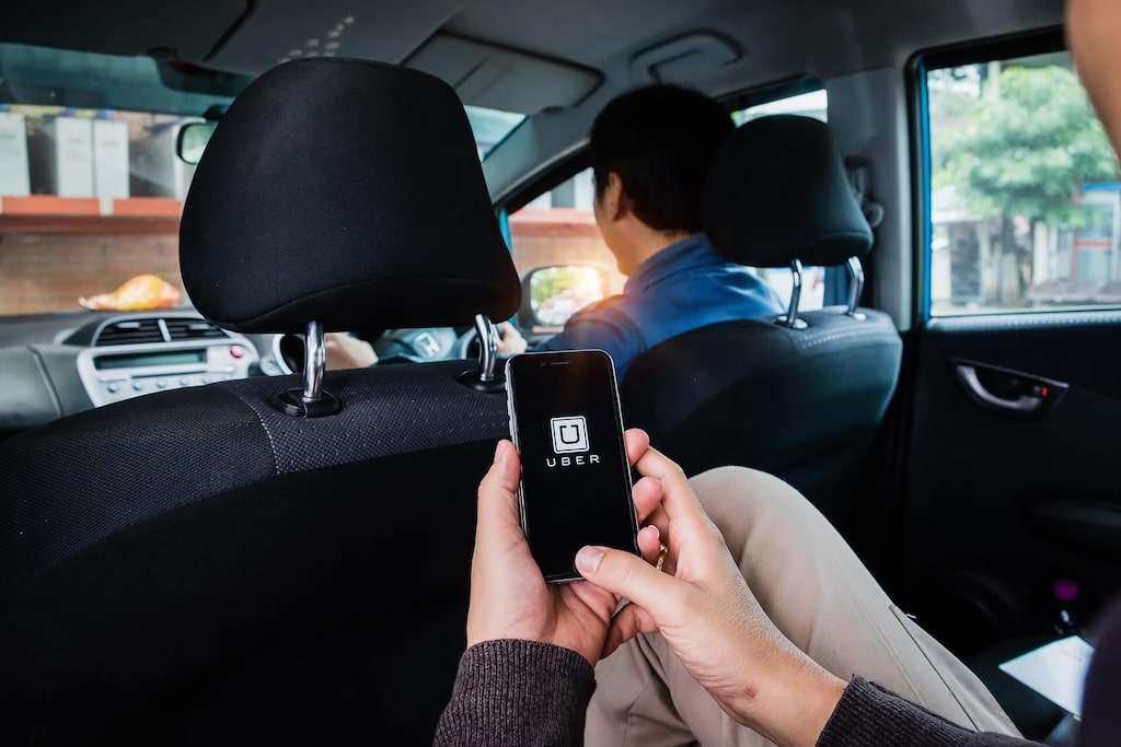 Person Holding Phone In A Backseat