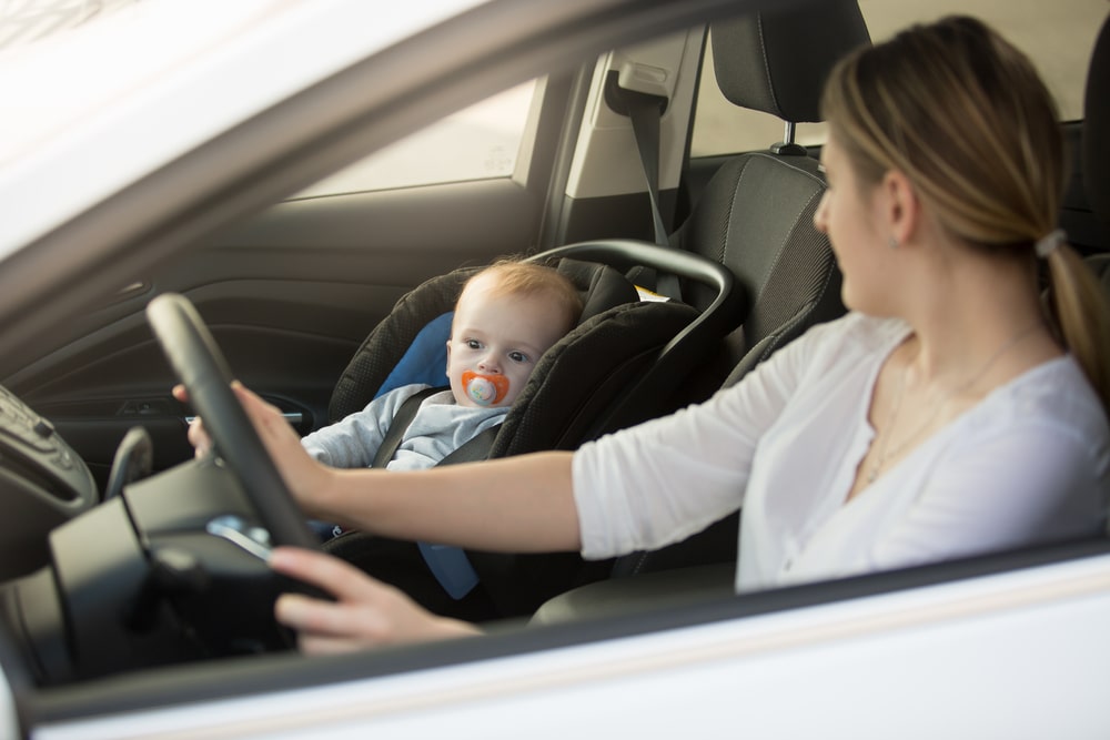 Parent Looking at a child who is fastened in the front seat